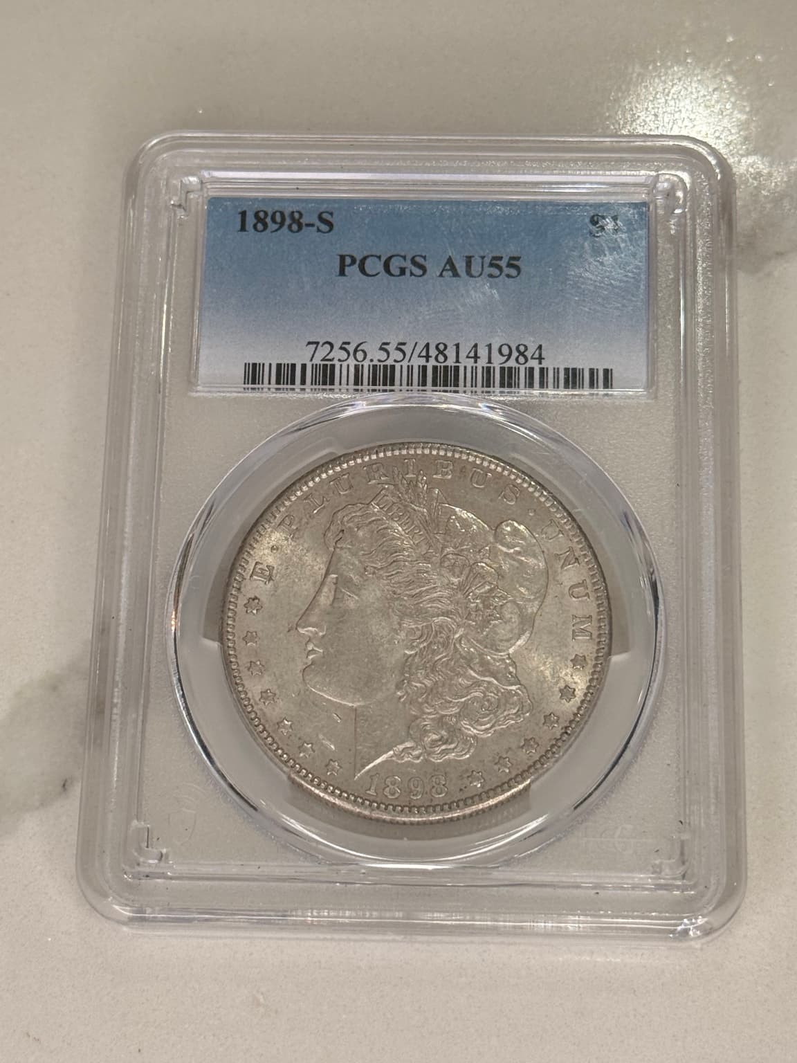 An actual 1898-S Morgan dollar in its PCGS AU55 holder, photographed for Jesse G Coins